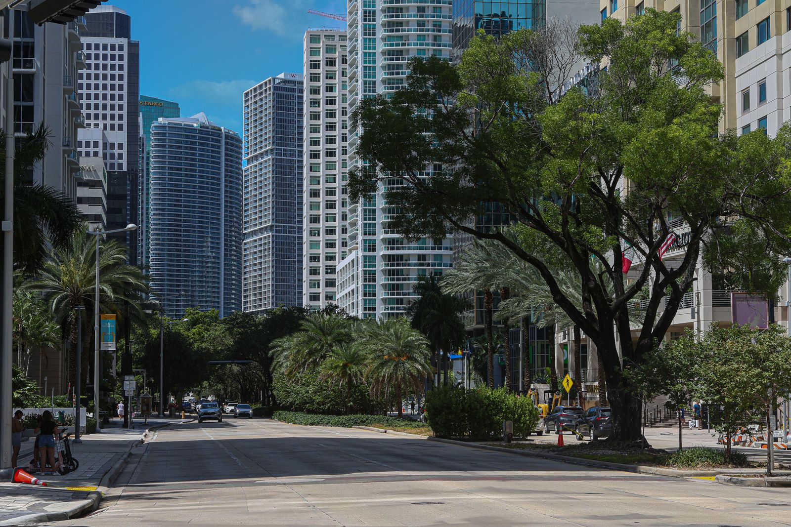 Downtown Miami street with skyscrapers and palm trees