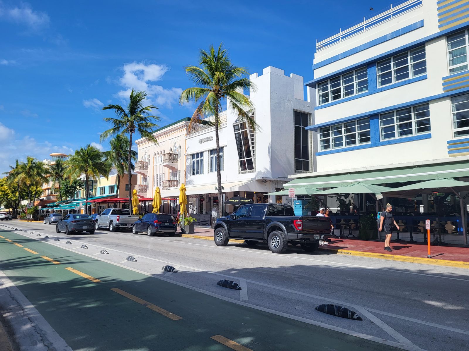 Art Deco buildings and palm trees along a Miami Beach street